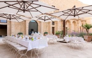 Tables elegantly set in the courtyard of Castello di Ugento